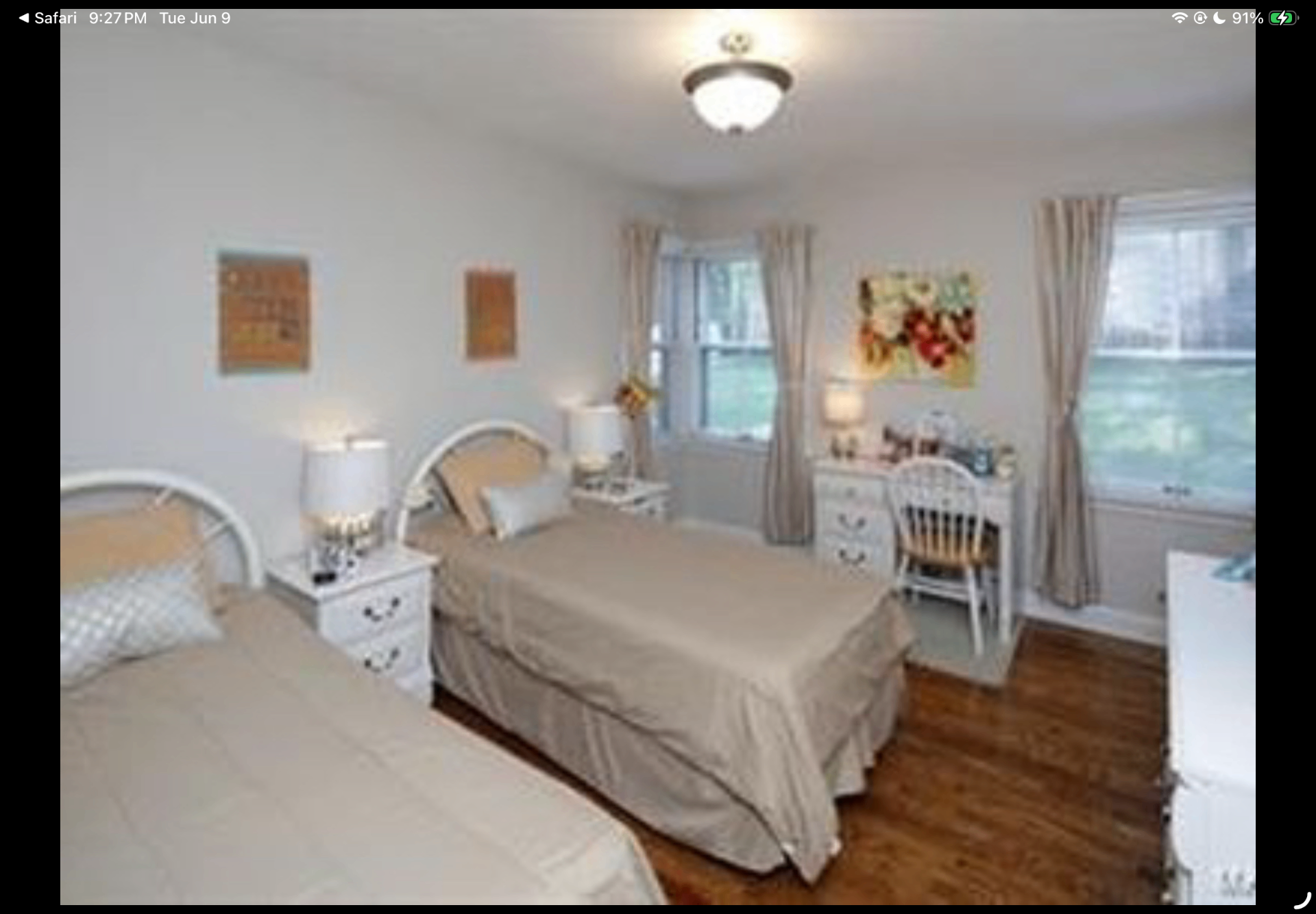 Bedroom with two twin beds, white furniture and large windows