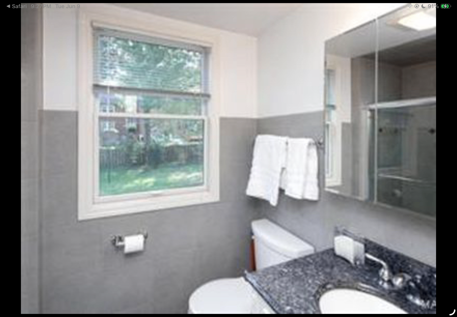 Bathroom with grey walls, granite vanity top and glass shower surround