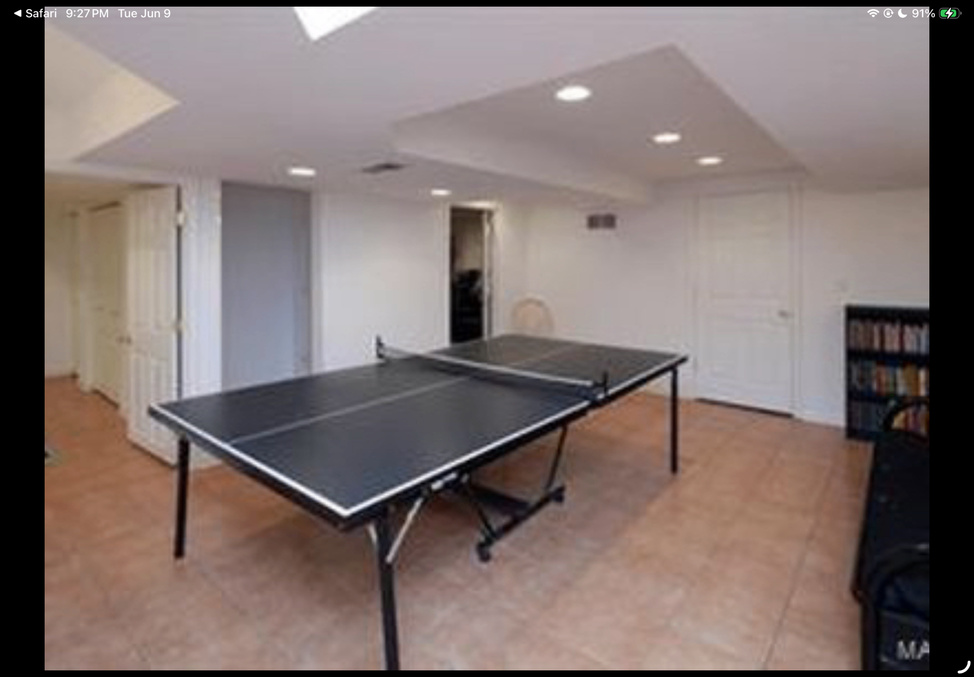 Lower-level recreation room with a ping pong table and recessed lighting